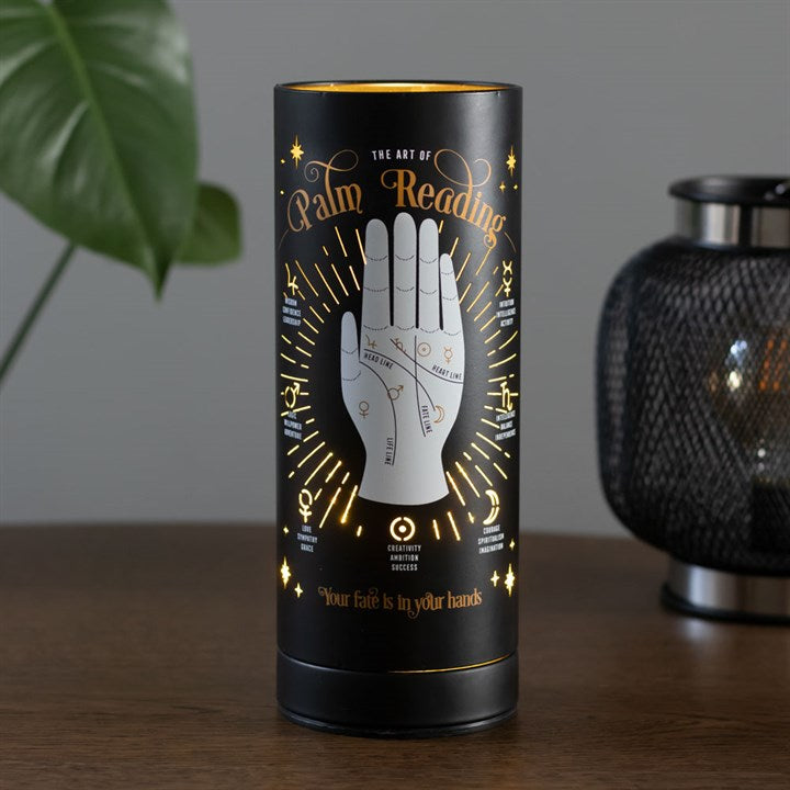 Decorative cylindrical product with palm reading design on a wooden surface.